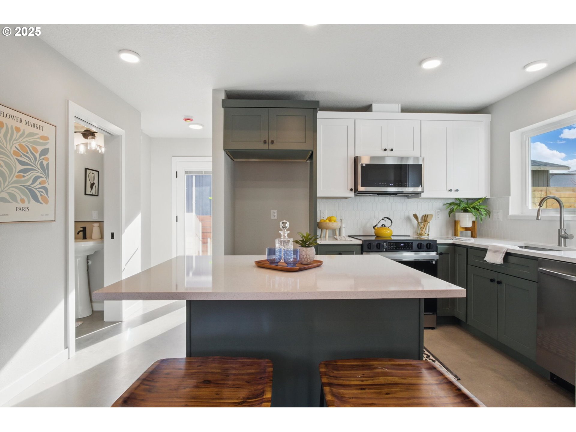 1123 Southeast Rhone Street, Unit B Portland, OR 97202 - Photo 7 of 30 a kitchen with a sink refrigerator and microwave