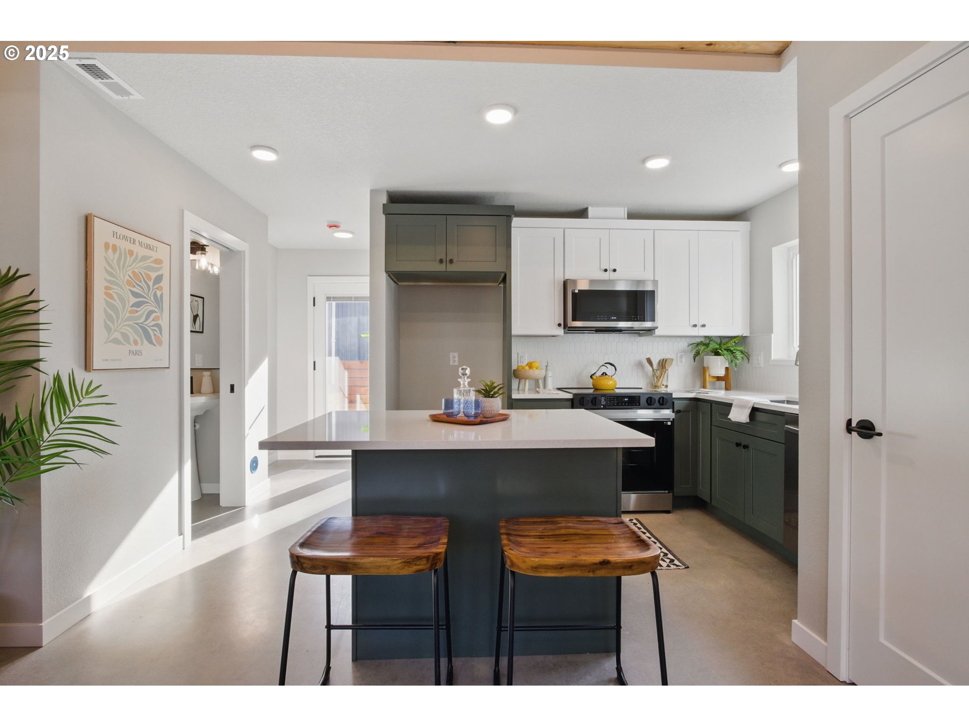 1123 Southeast Rhone Street, Unit B Portland, OR 97202 - Photo 8 of 30 a kitchen with a sink cabinets and wooden floor