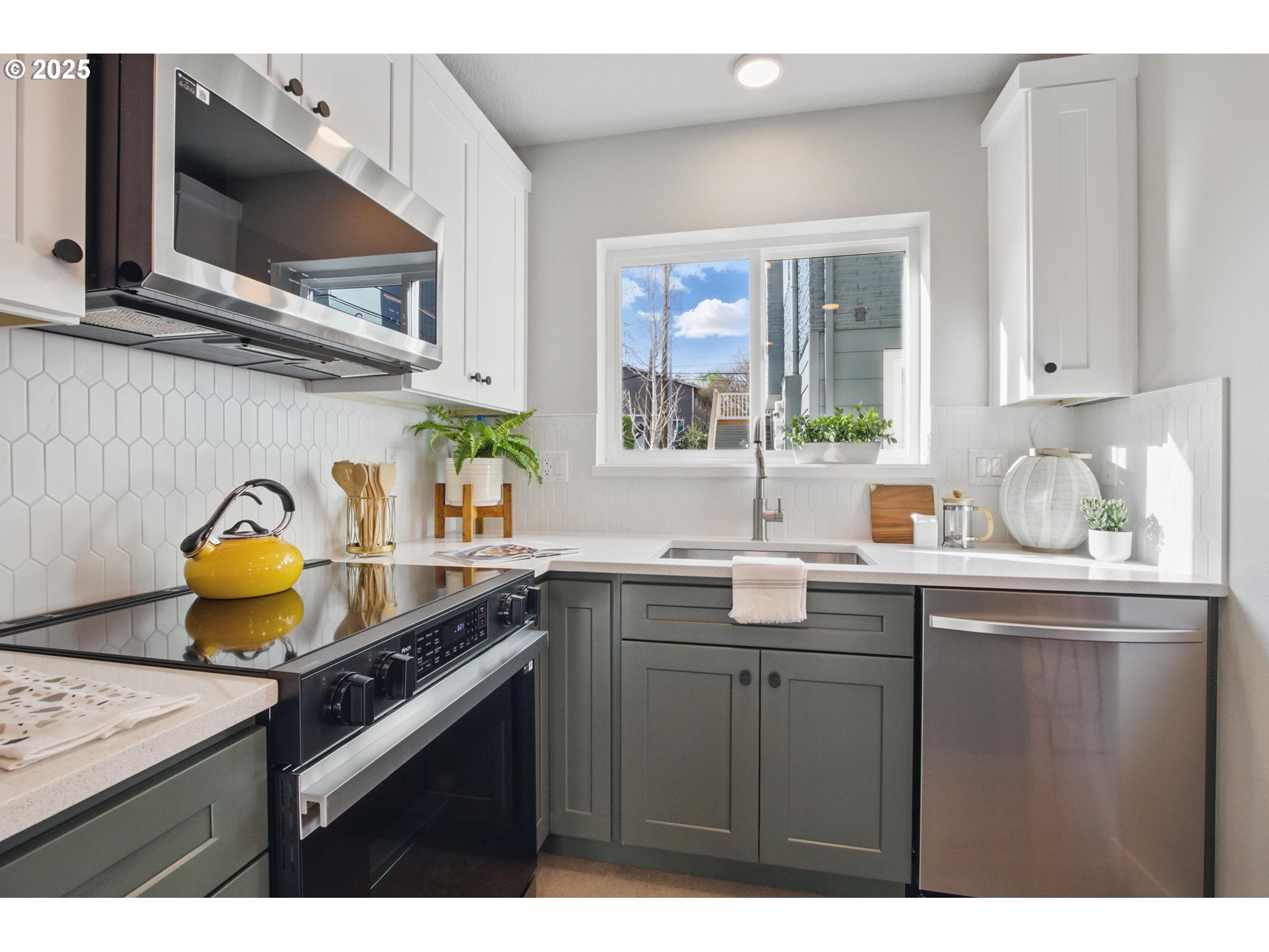 1123 Southeast Rhone Street, Unit B Portland, OR 97202 - Photo 10 of 30 a kitchen with a sink a stove and cabinets