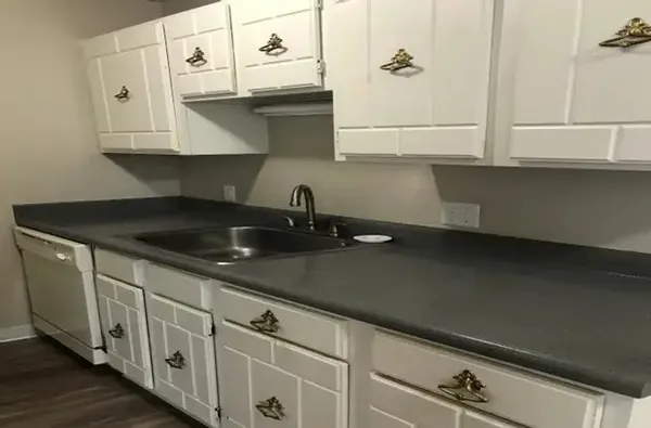 a kitchen with a sink and cabinets