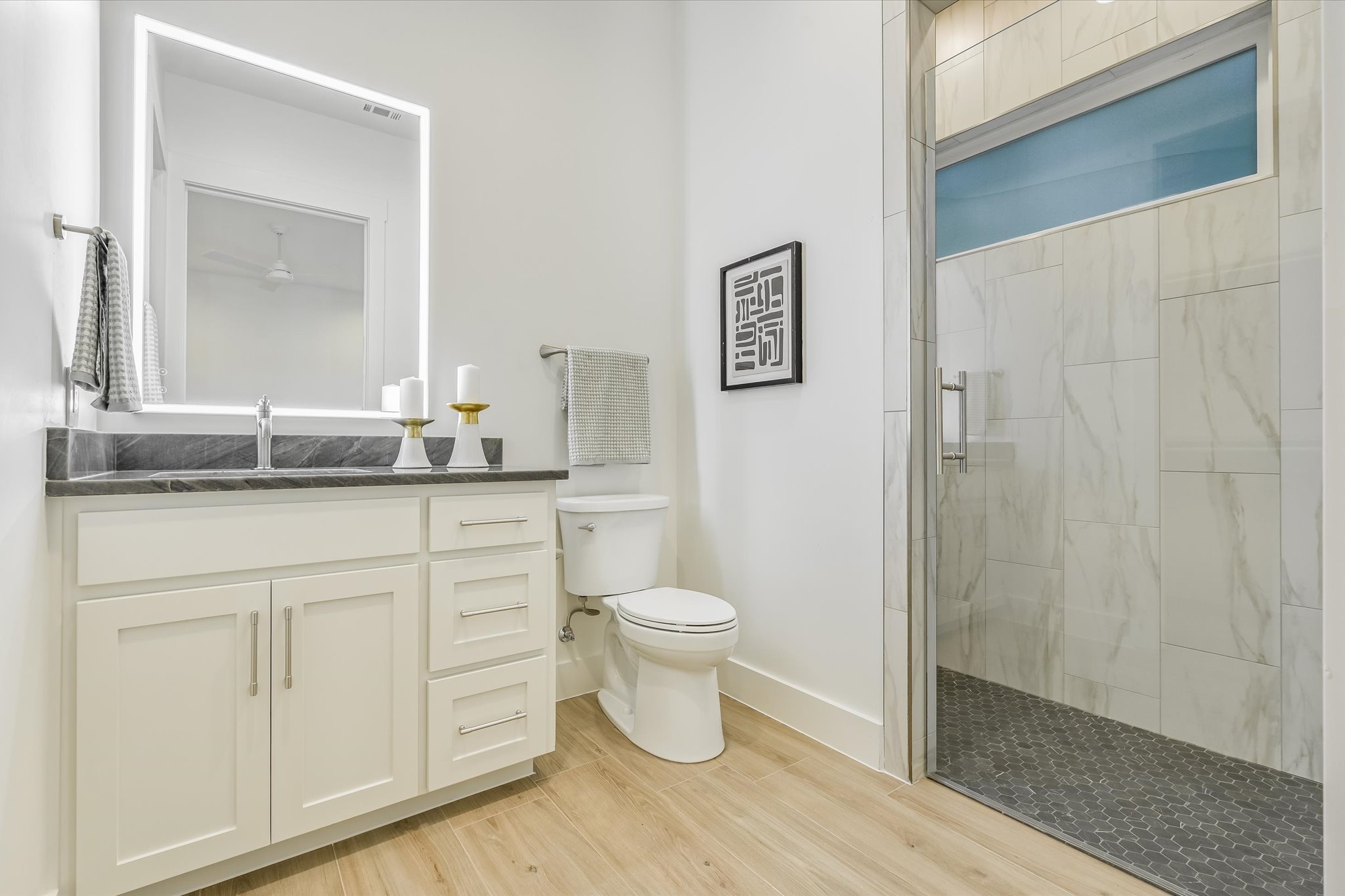 410 Shady Tree Drive Georgetown, TX 78633 - Photo 19 of 40 Bathroom with a stall shower, vanity, and light wood-style floors