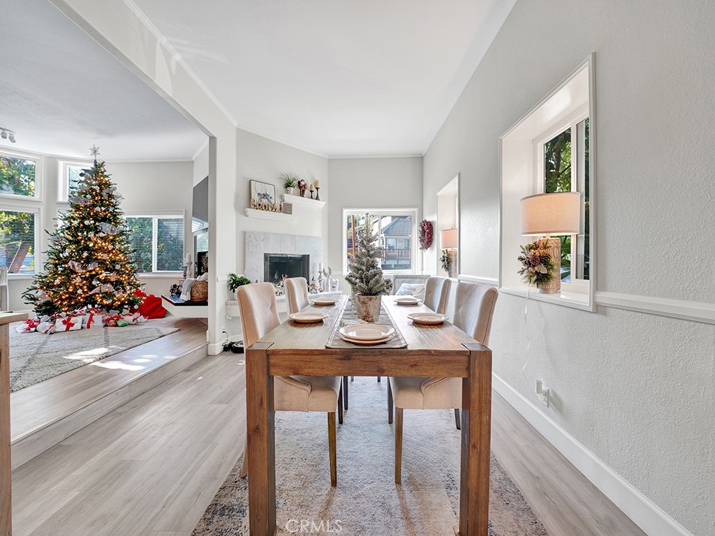 34102 Crystal Lantern Dana Point, CA 92629 - Photo 12 of 43 a view of a dining room and livingroom with furniture wooden floor a chandelier