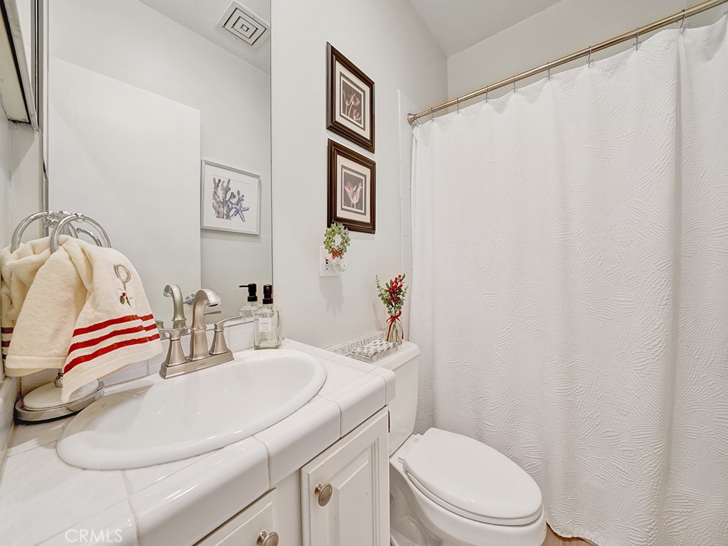 34102 Crystal Lantern Dana Point, CA 92629 - Photo 18 of 43 a bathroom with a sink vanity mirror and toilet
