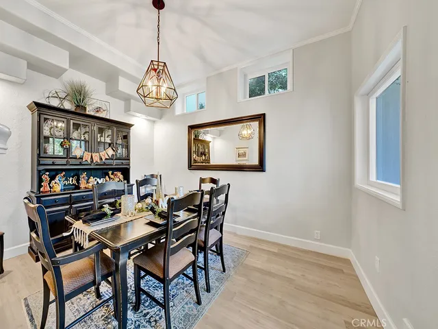 a view of a dining room with furniture wooden floor and a chandelier