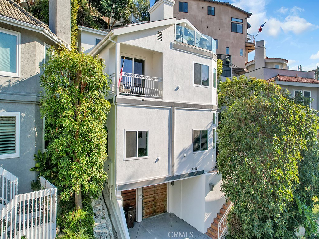 34102 Crystal Lantern Dana Point, CA 92629 - Photo 2 of 43 a front view of a house with a yard