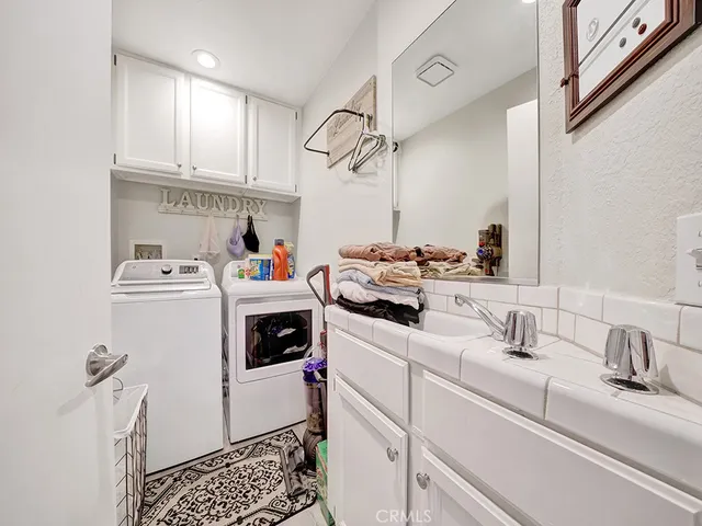 a utility room with sink dryer and washer