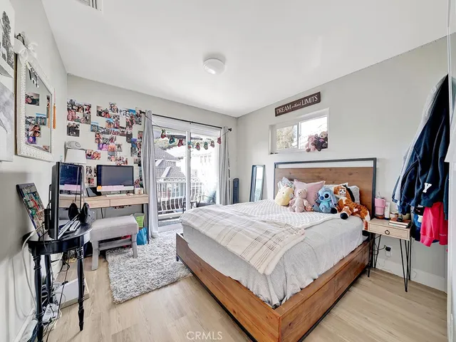 a bedroom with a bed a couch and dresser