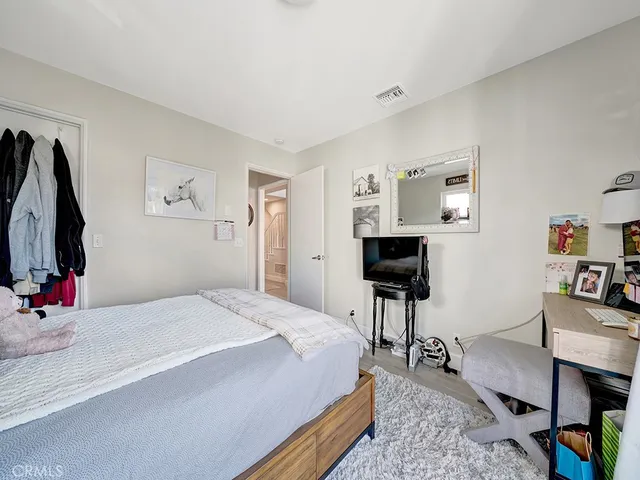 a bedroom with a bed and a desk