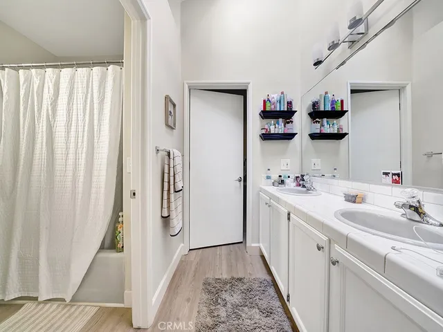 a bathroom with a double vanity sink and a mirror