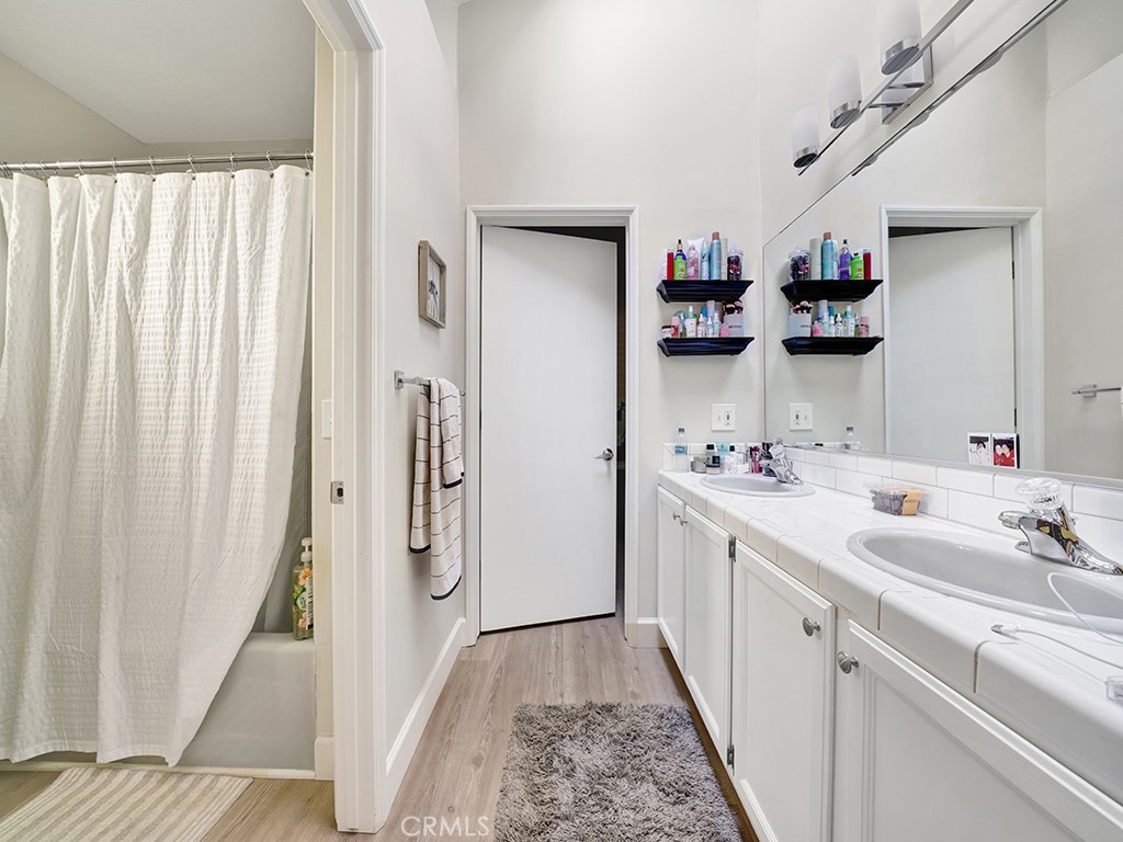 34102 Crystal Lantern Dana Point, CA 92629 - Photo 26 of 43 a bathroom with a double vanity sink and a mirror