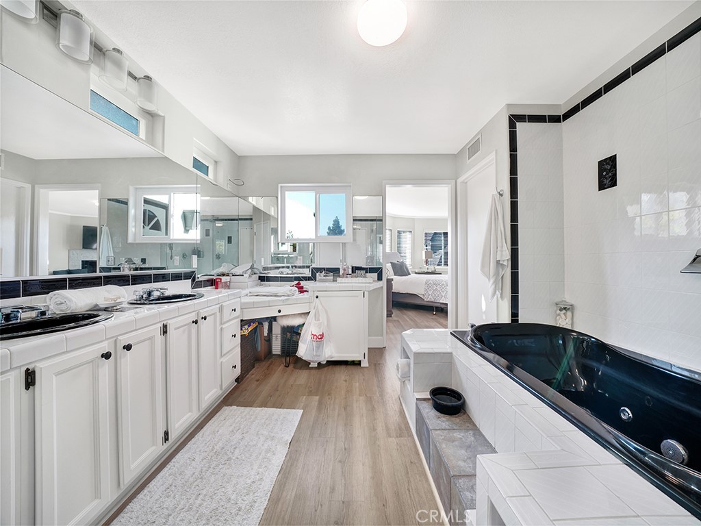 34102 Crystal Lantern Dana Point, CA 92629 - Photo 31 of 43 a large white kitchen with a lot of white cabinets and stainless steel appliances