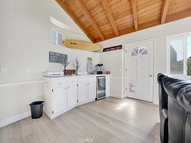 a kitchen with a refrigerator and white cabinets