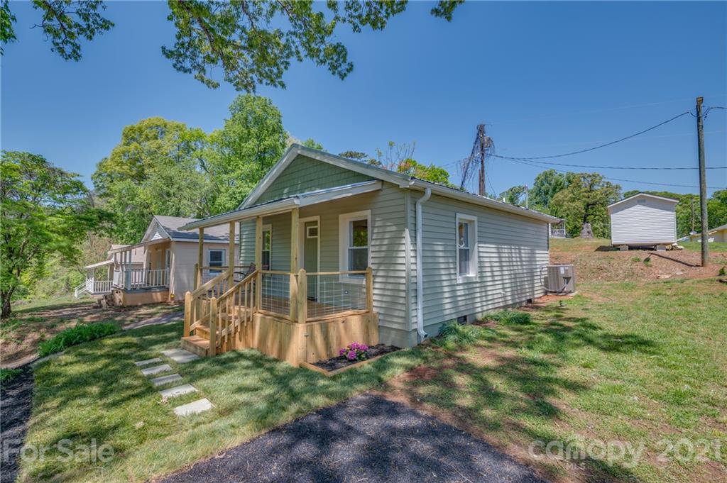 a backyard of a house with table and chairs