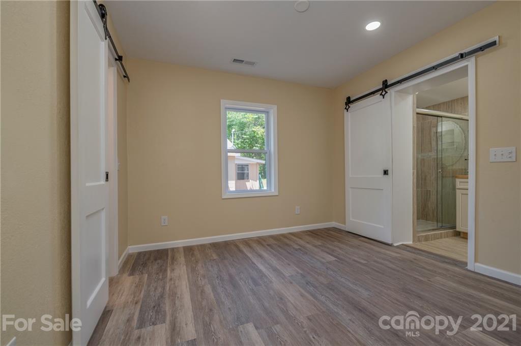 116 Riley Court Rutherfordton, NC 28139 - Photo 11 of 28 a view of an empty room with wooden floor and a window