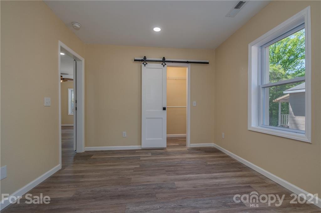116 Riley Court Rutherfordton, NC 28139 - Photo 14 of 28 a view of an empty room with wooden floor and a window
