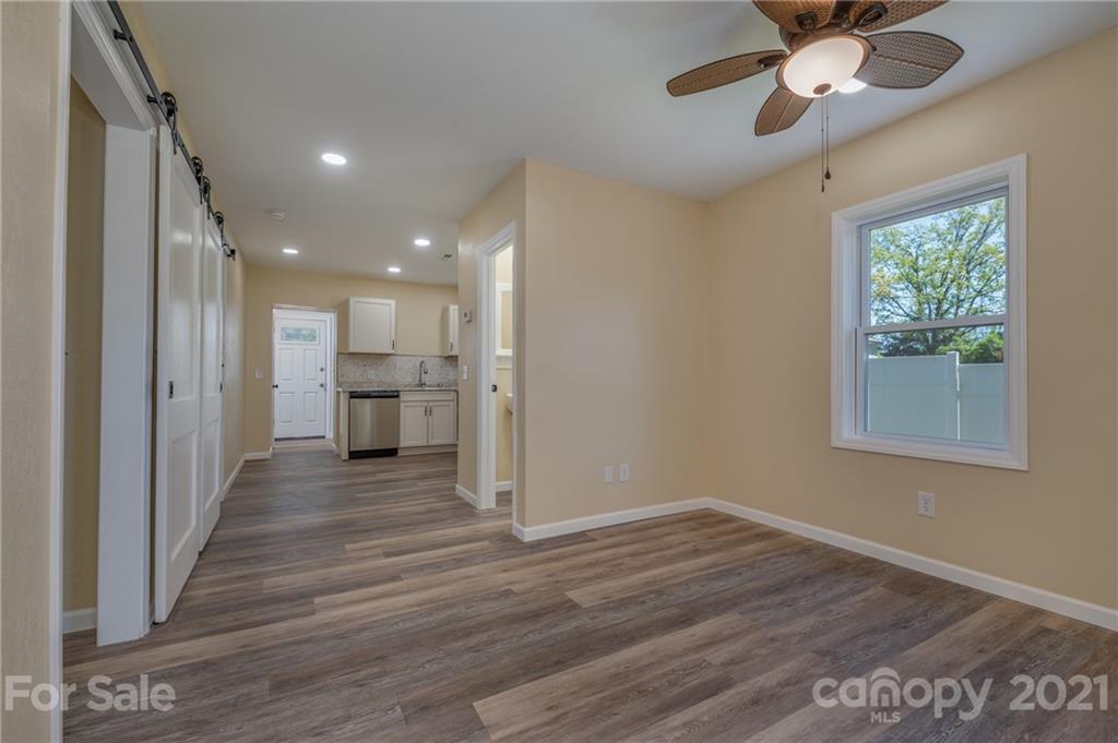 116 Riley Court Rutherfordton, NC 28139 - Photo 5 of 28 a view of a hallway with wooden floor and a kitchen