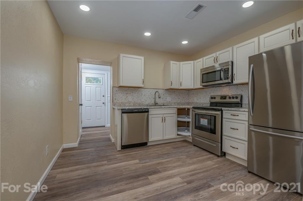 116 Riley Court Rutherfordton, NC 28139 - Photo 6 of 28 a kitchen with a refrigerator and a stove top oven