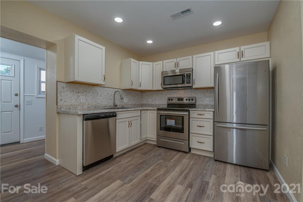 116 Riley Court Rutherfordton, NC 28139 - Photo 7 of 28 a kitchen with kitchen island wooden floors appliances and cabinets