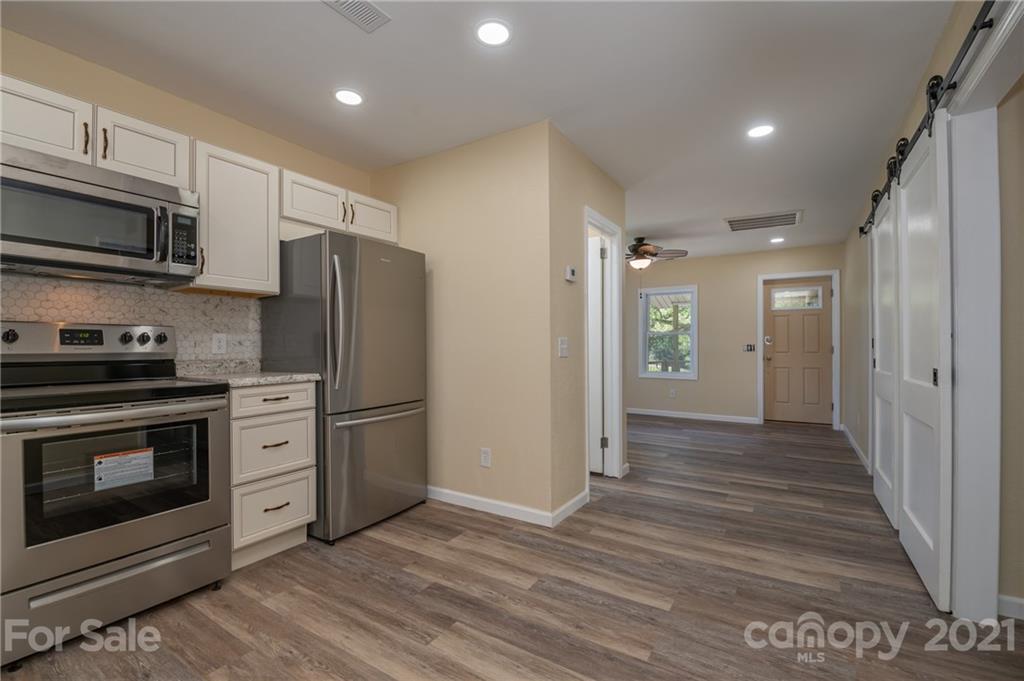 116 Riley Court Rutherfordton, NC 28139 - Photo 8 of 28 a kitchen with stainless steel appliances granite countertop a refrigerator stove and sink