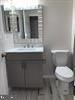 2503 Stokes Road Mount Laurel, NJ 08054 - Photo 11 of 22 a bathroom with a toilet sink and mirror