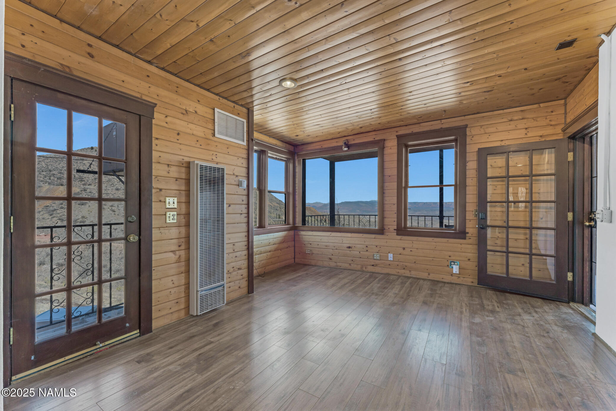 222 1st Avenue, Unit B Jerome, AZ 86331 - Photo 4 of 14 an empty room with wooden floor and windows