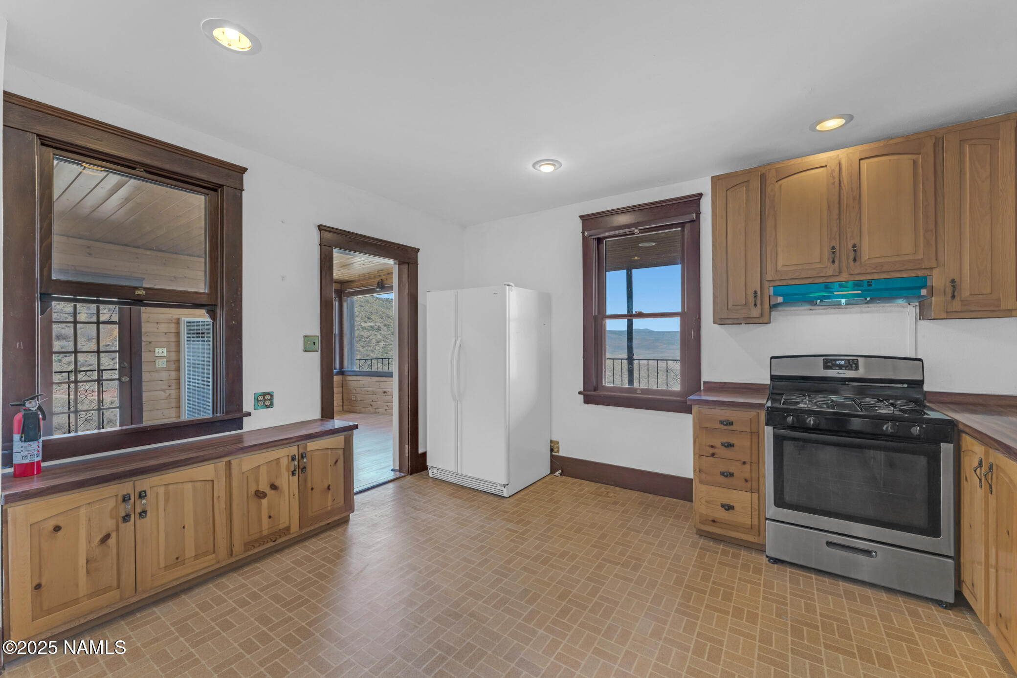 222 1st Avenue, Unit B Jerome, AZ 86331 - Photo 6 of 14 a kitchen with stainless steel appliances granite countertop a stove and a refrigerator
