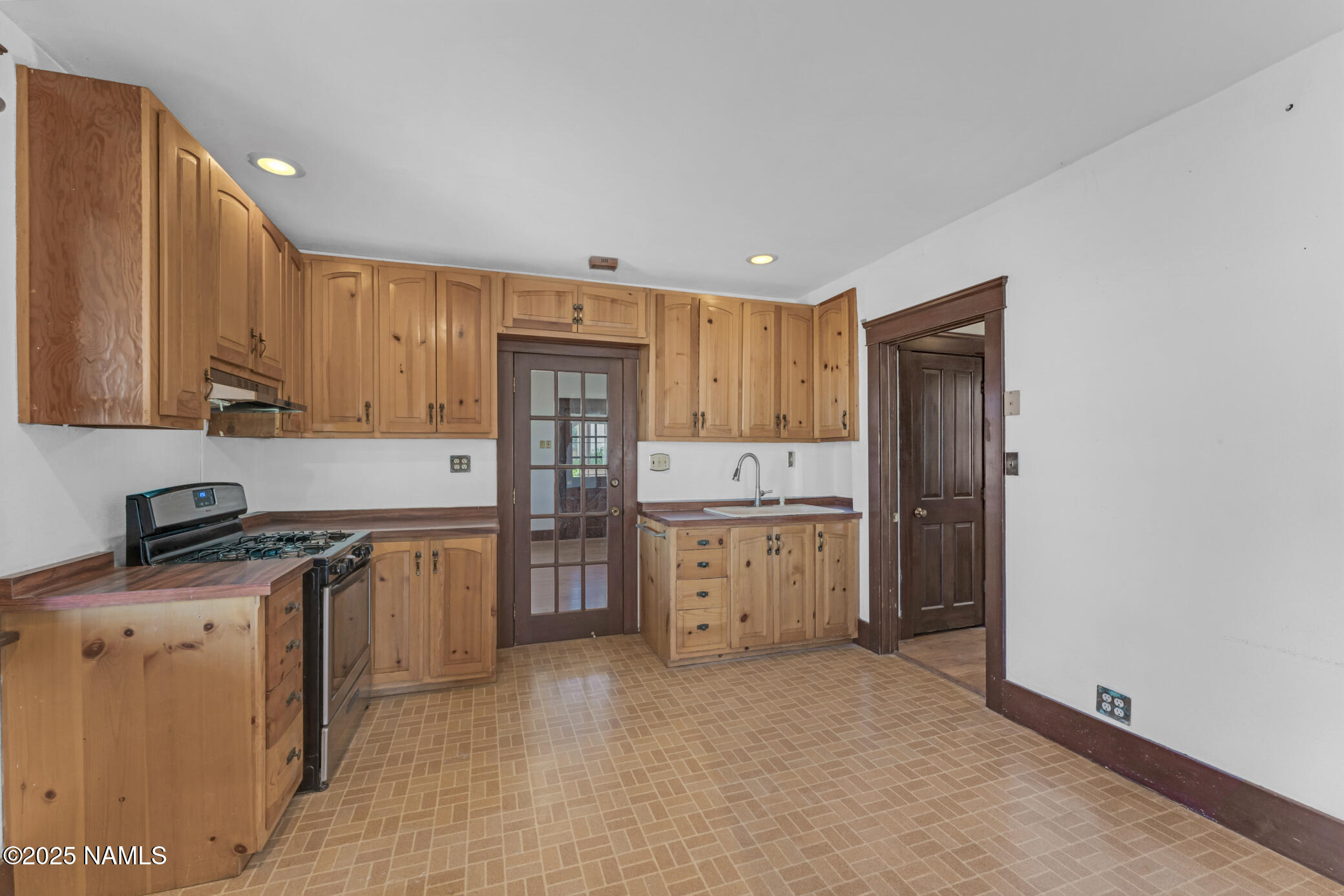 222 1st Avenue, Unit B Jerome, AZ 86331 - Photo 7 of 14 a kitchen with a sink a stove and cabinets