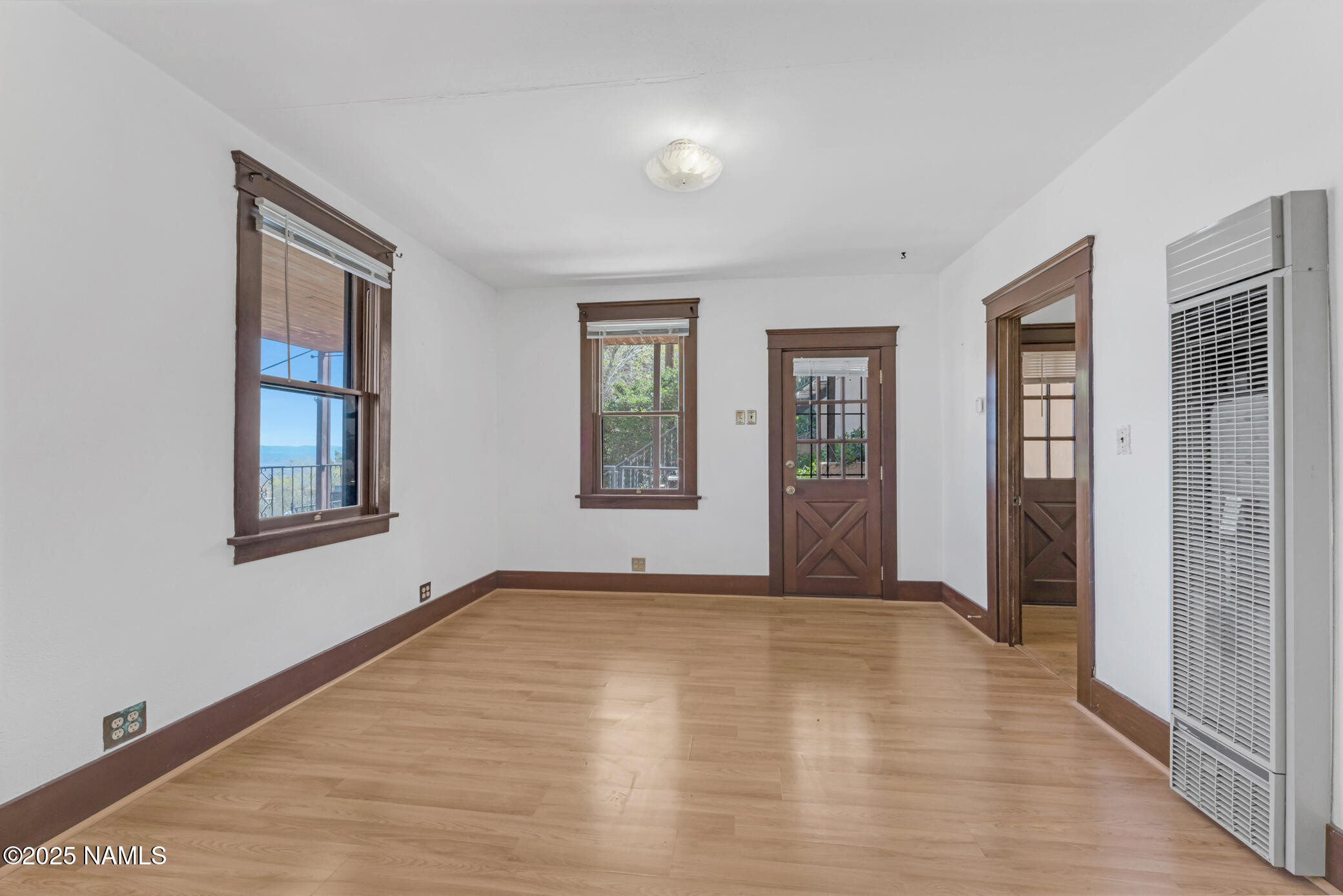 222 1st Avenue, Unit B Jerome, AZ 86331 - Photo 10 of 14 a view of an empty room with window and hardwood floor