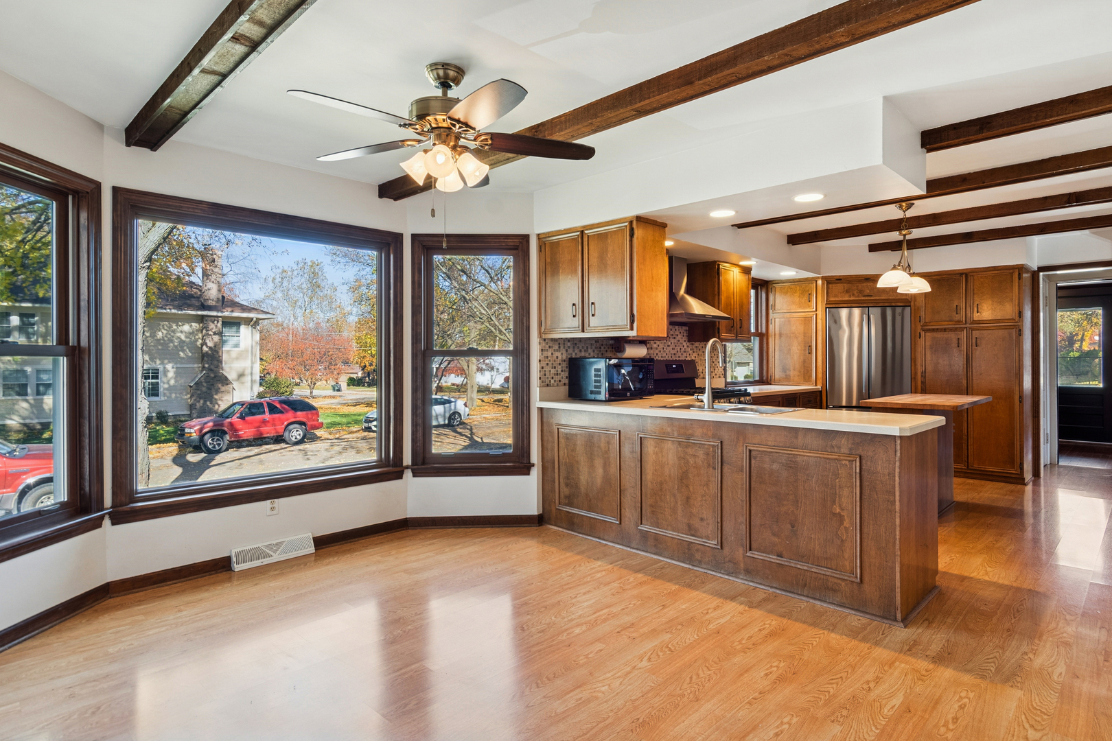55 Garfield Street Oswego, IL 60543 - Photo 15 of 27 a living room with stainless steel appliances kitchen island granite countertop furniture and a large window