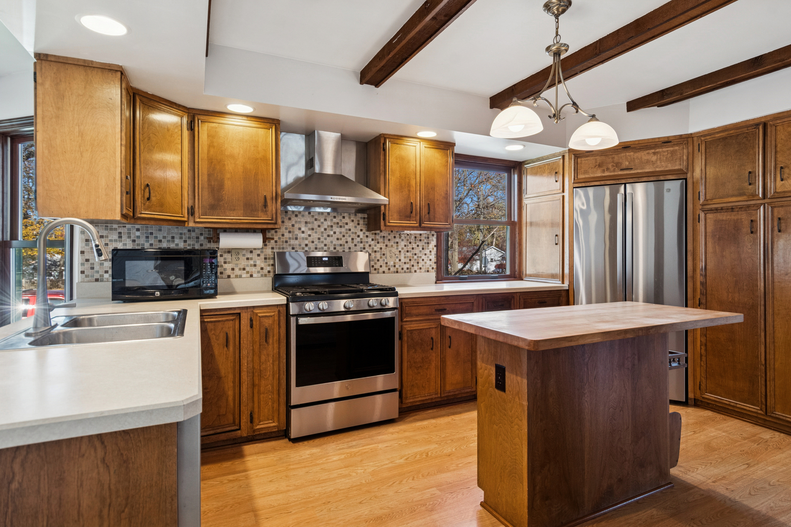 55 Garfield Street Oswego, IL 60543 - Photo 17 of 27 a kitchen with stainless steel appliances granite countertop a stove and a refrigerator