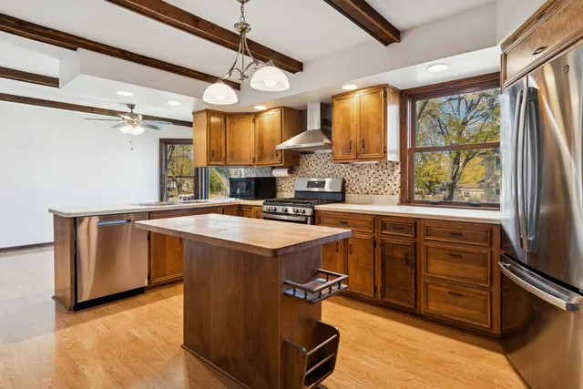 a kitchen with granite countertop a sink appliances cabinets and a counter top space