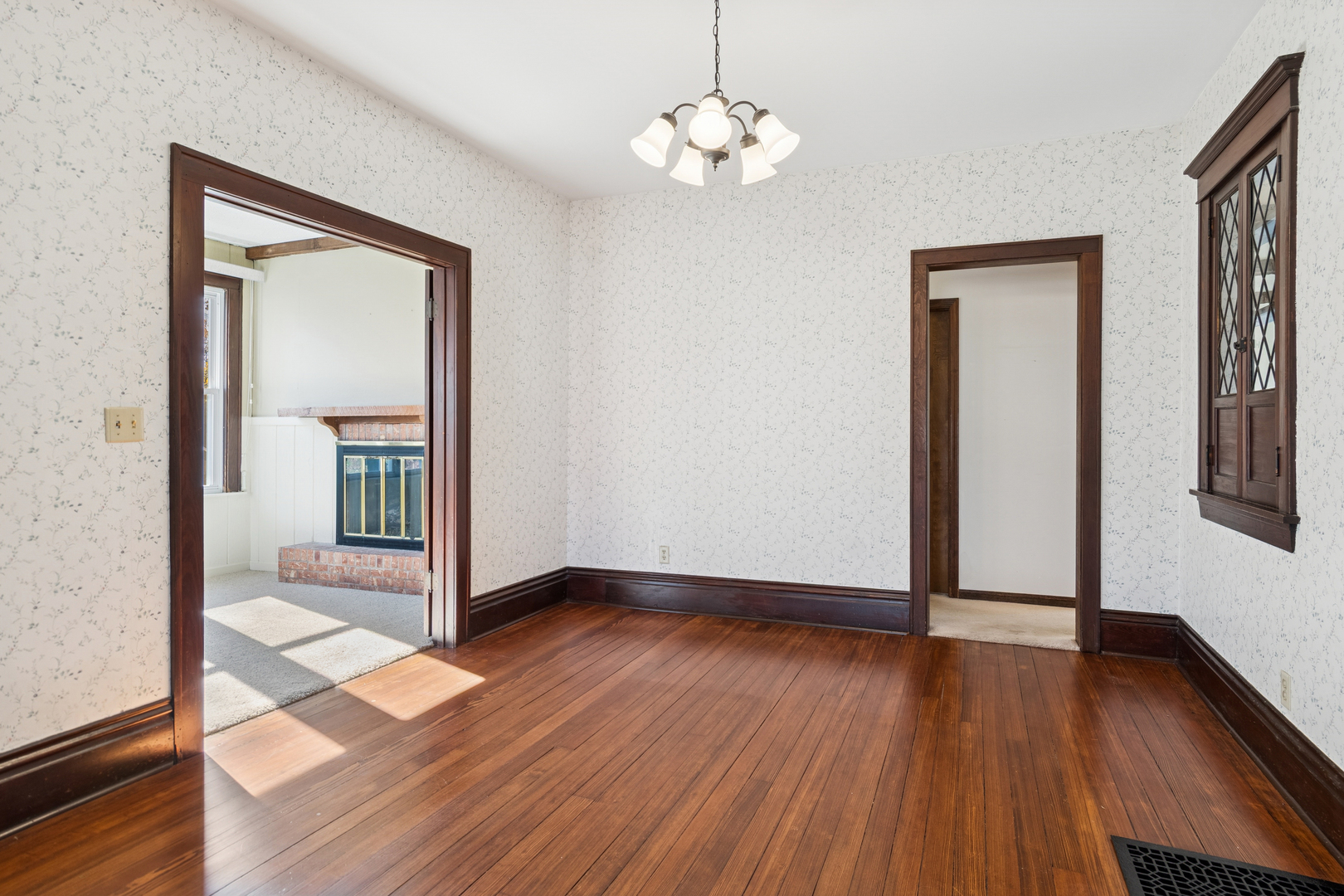 55 Garfield Street Oswego, IL 60543 - Photo 3 of 27 an empty room with wooden floor mirror and windows
