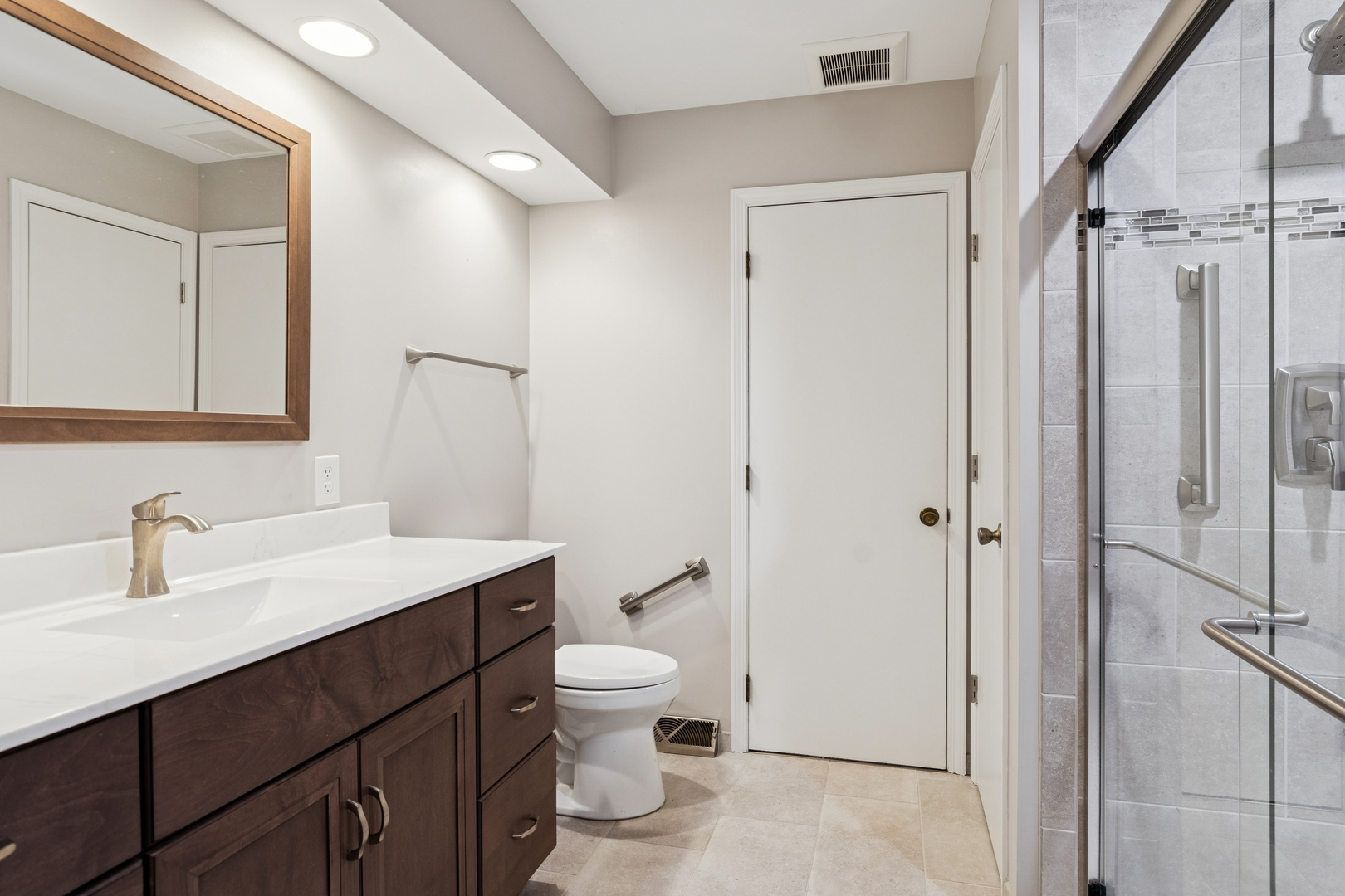 55 Garfield Street Oswego, IL 60543 - Photo 8 of 27 a bathroom with a toilet a sink and a mirror