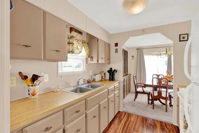 a kitchen with sink cabinets and dining table