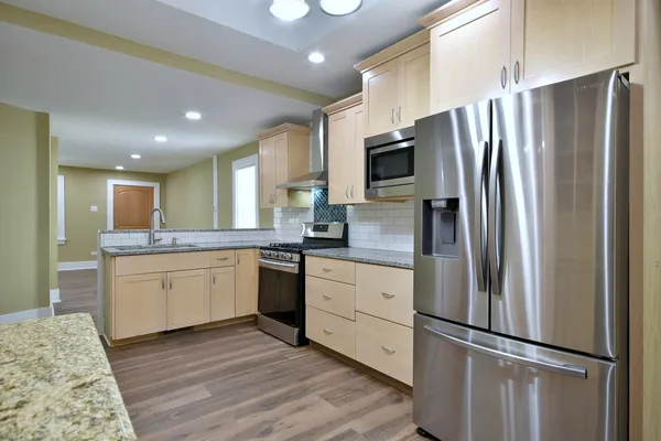 a bathroom with a granite countertop sink mirror and