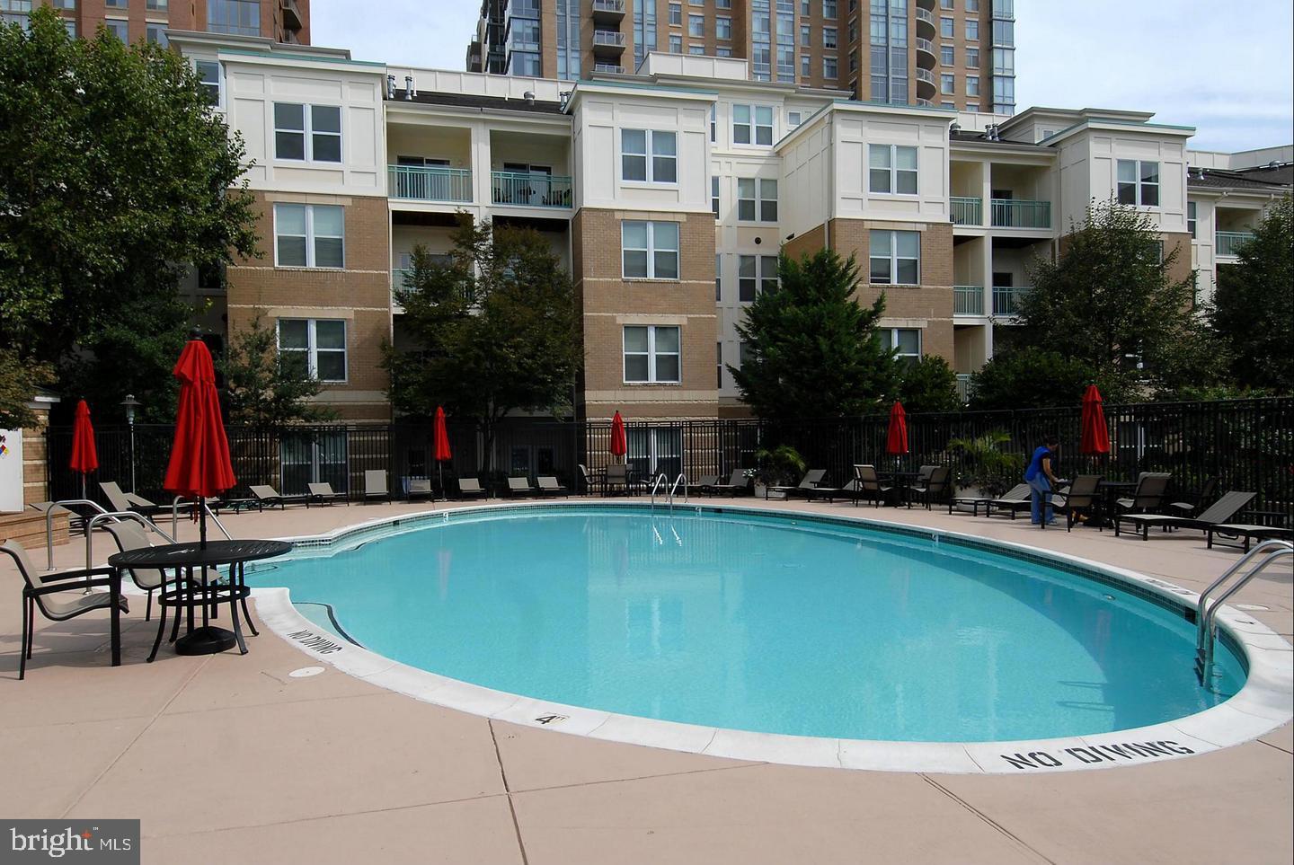 12000 Market Street, Unit 445 Reston, VA 20190 - Photo 3 of 4 a swimming pool with outdoor seating and yard