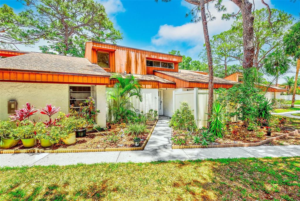 2064 Sunset Point Road, Unit 73 Clearwater, FL 33765 - Photo 40 of 58 front view of a house with a yard