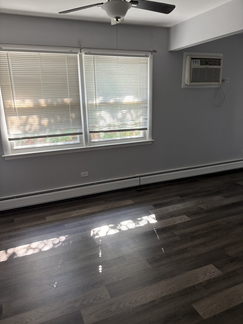 4521 Maple Avenue, Unit 2S Brookfield, IL 60513 - Photo 3 of 8 a view of empty room with wooden floor and fan
