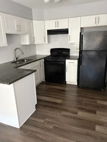 a kitchen with a sink stove and refrigerator