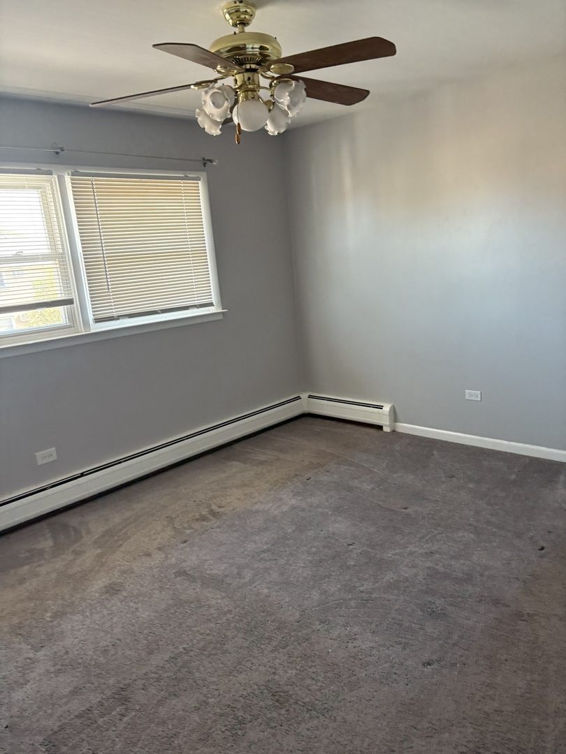 4521 Maple Avenue, Unit 2S Brookfield, IL 60513 - Photo 6 of 8 an empty room with windows and fan