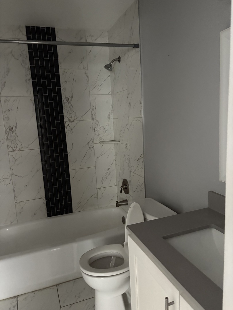 4521 Maple Avenue, Unit 2S Brookfield, IL 60513 - Photo 7 of 8 a bathroom with a sink and a toilet