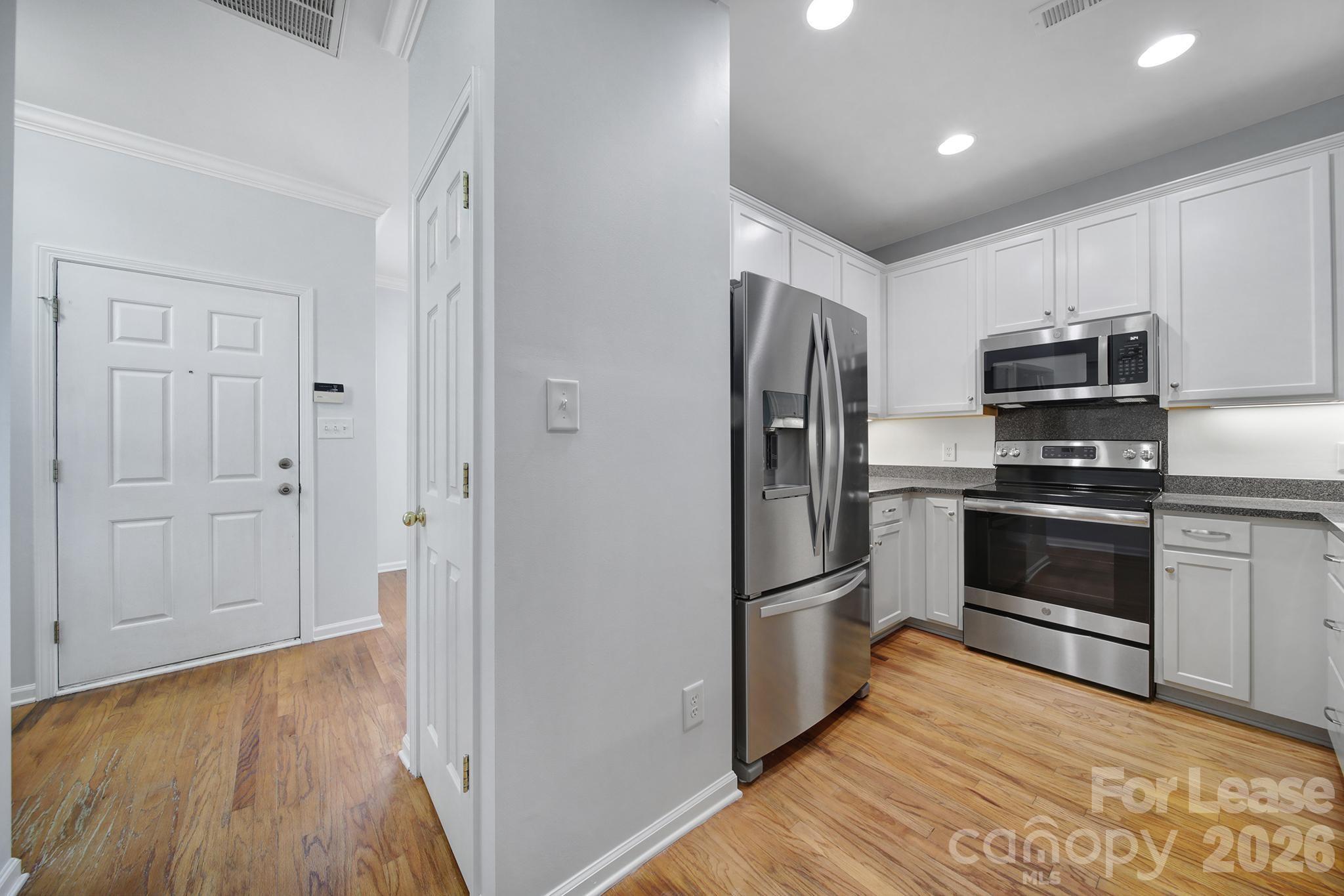 14844 Scothurst Lane Charlotte, NC 28277 - Photo 16 of 33 a kitchen with a refrigerator and a stove top oven