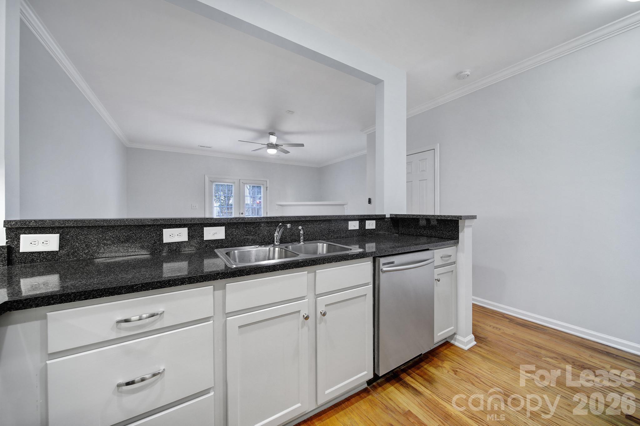14844 Scothurst Lane Charlotte, NC 28277 - Photo 17 of 33 a kitchen with granite countertop white cabinets and a sink