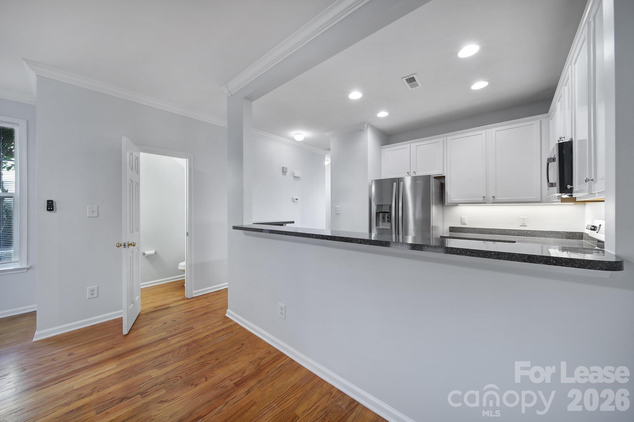 14844 Scothurst Lane Charlotte, NC 28277 - Photo 18 of 33 a view of kitchen with wooden floor