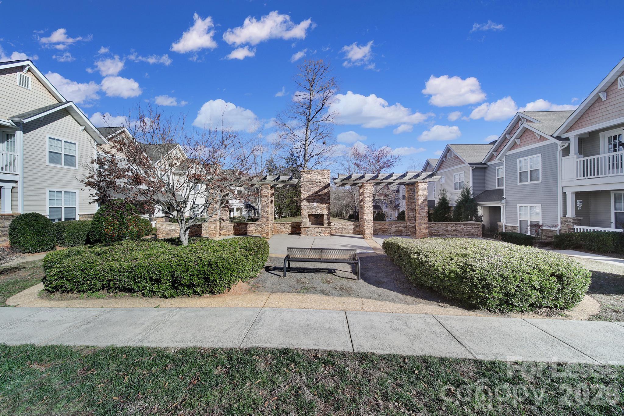 14844 Scothurst Lane Charlotte, NC 28277 - Photo 30 of 33 a view of a white building with a yard