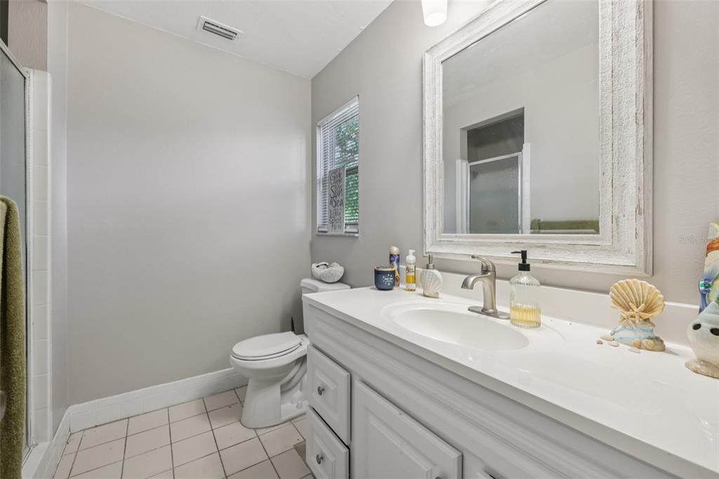 3 Silver Court Ocala, FL 34472 - Photo 11 of 25 a bathroom with a sink a toilet and mirror