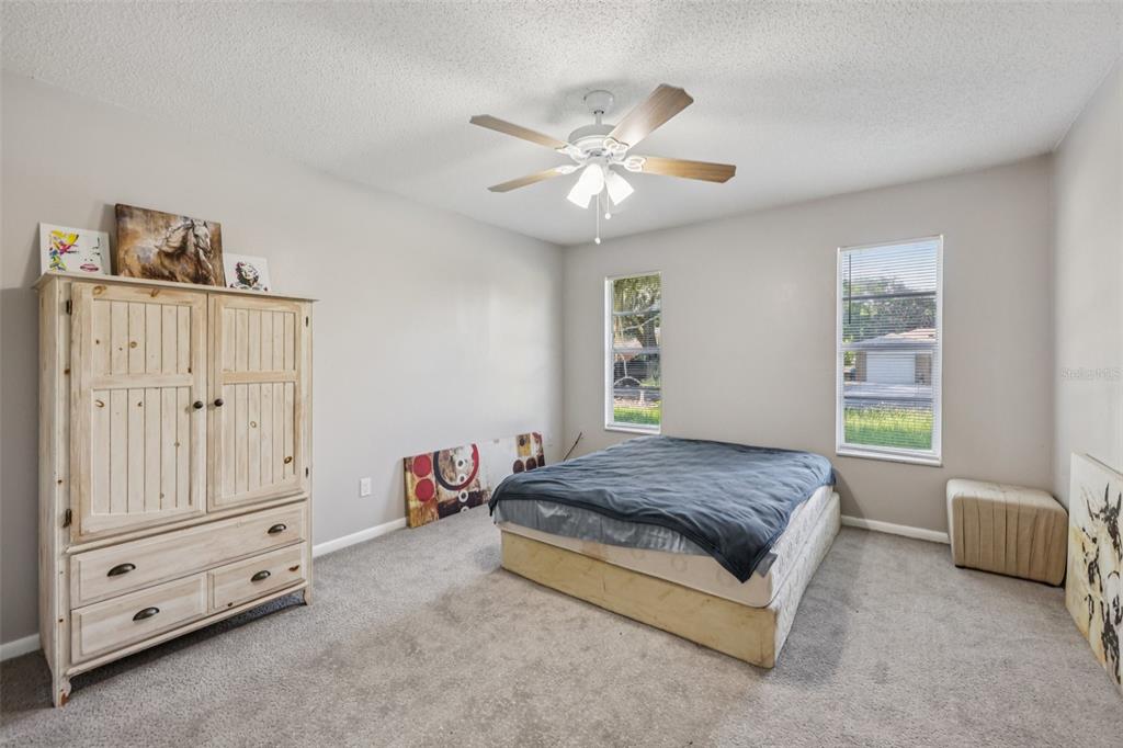 3 Silver Court Ocala, FL 34472 - Photo 13 of 25 a spacious bedroom with a bed and a window