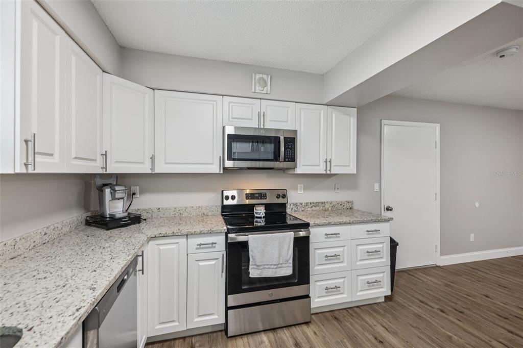 3 Silver Court Ocala, FL 34472 - Photo 8 of 25 a kitchen with granite countertop white cabinets and stainless steel appliances