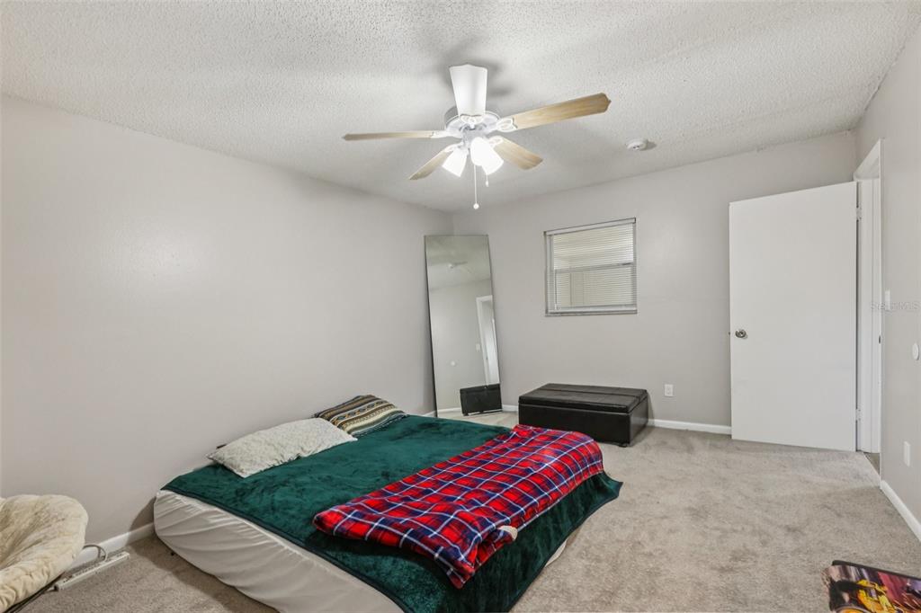 3 Silver Court Ocala, FL 34472 - Photo 10 of 25 a bedroom with a bed and a chandelier