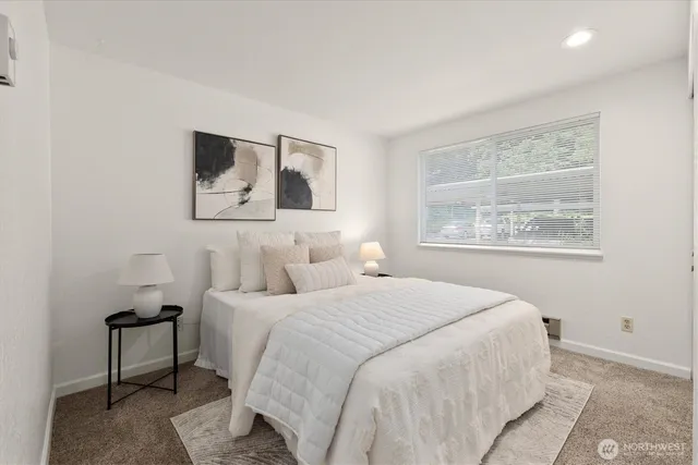 a bedroom with a bed and a window